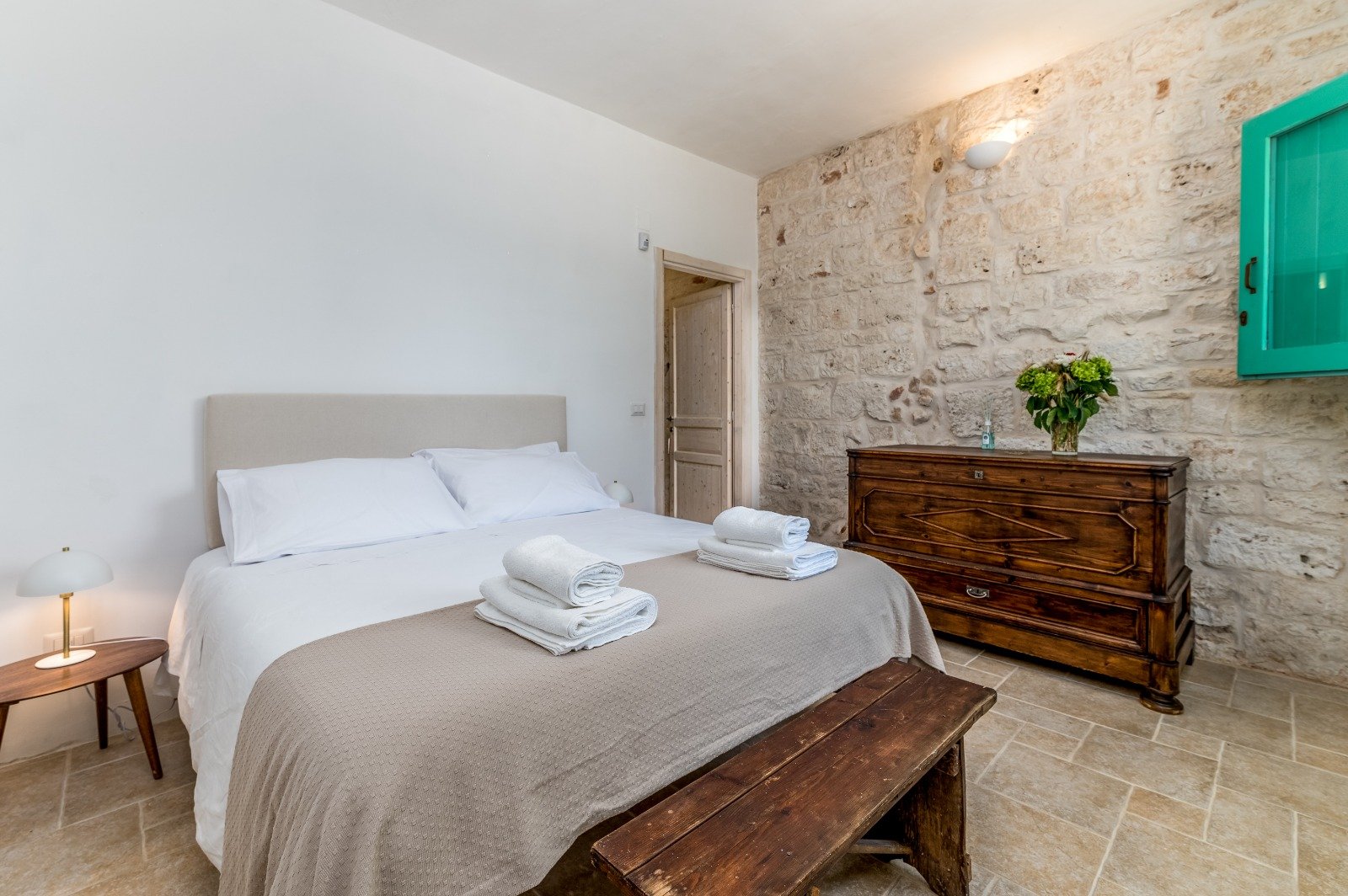 Bedroom with green details at Masseria Bel Cortile