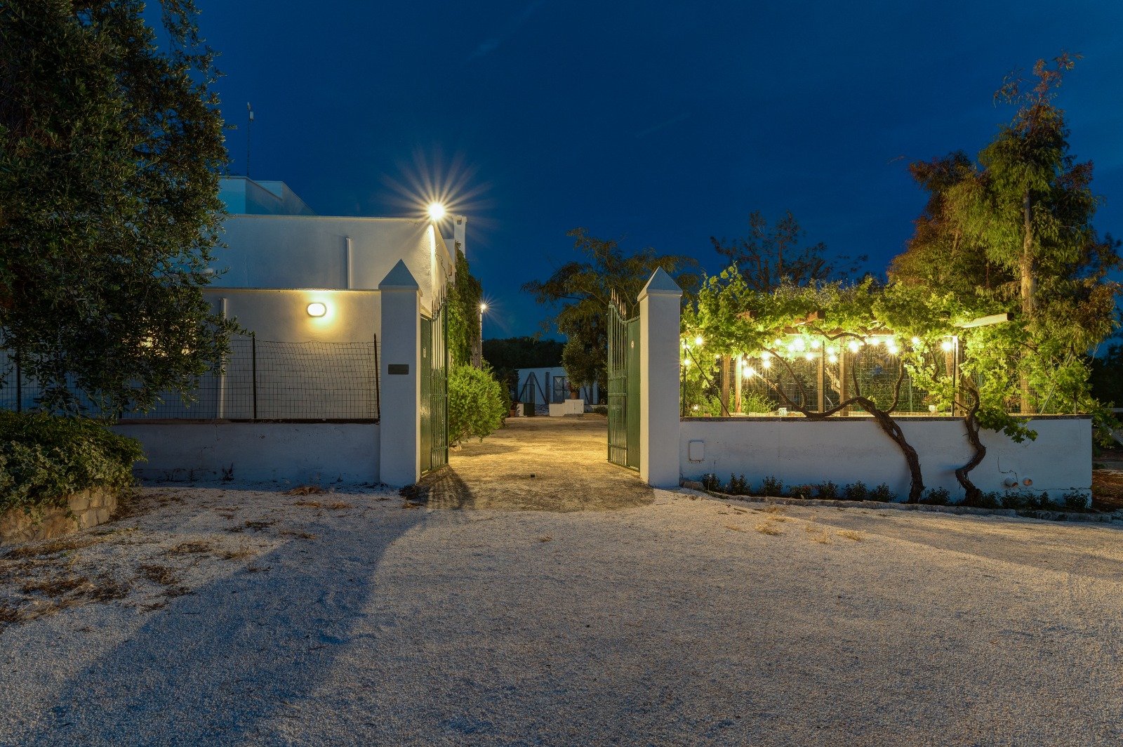 The entrance of the masseria lit up in the evening, Contrada Cervarolo, Ostuni