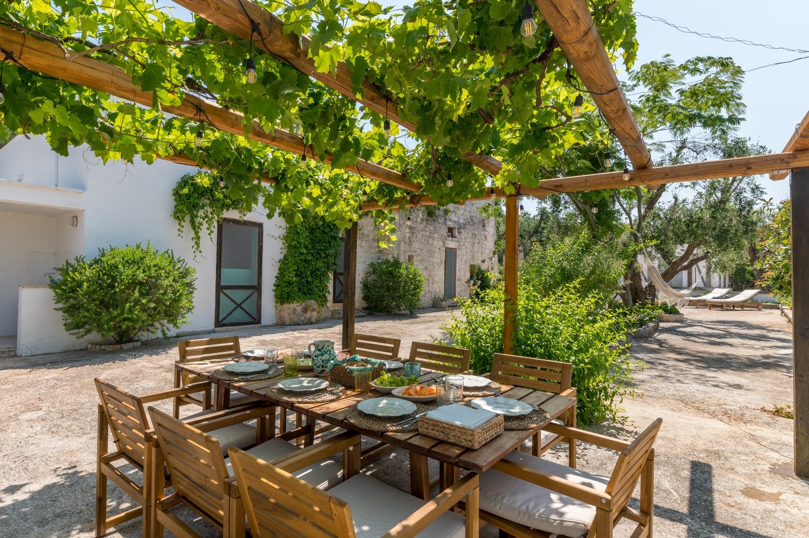 Pergola with a table laid for a meal at Masseria Bel Cortile